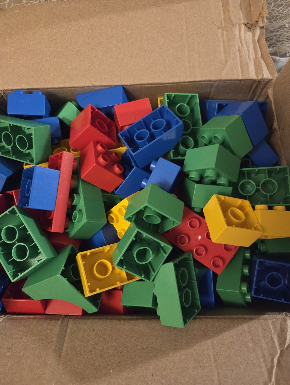 Box full of duplo kids bright colored legos